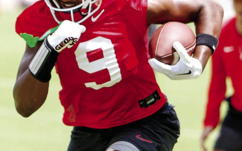 Georgia tight end Ethan Barbour runs over cones during a drill on the first day of fall camp. LANCE McCURLEY/Staff