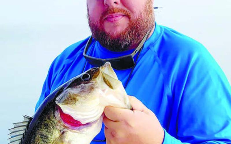 The author with a largemouth bass caught on a spoon. CONTRIBUTED