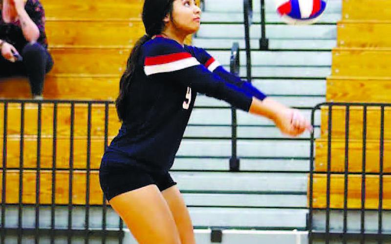 Leslye Arriola (9) hits a return over the net during a volley. ARELLA CASH/Staff