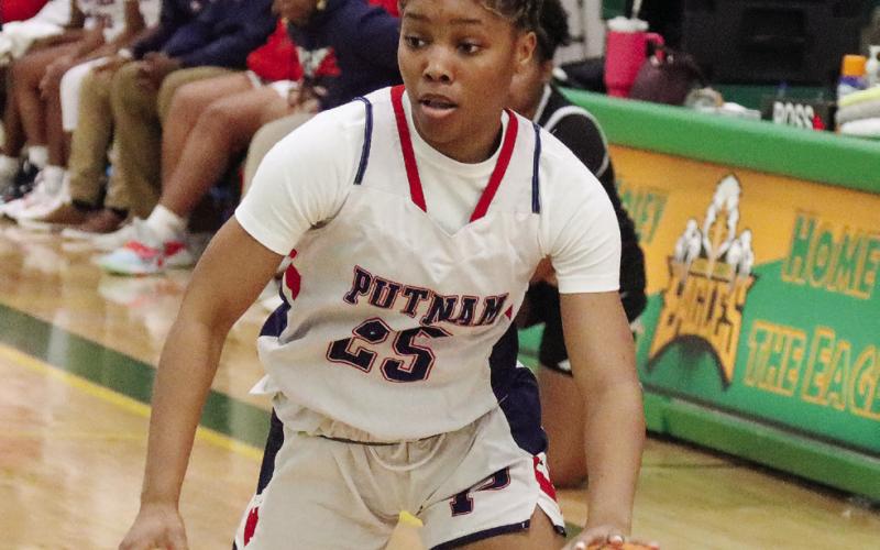 Lady War Eagles’ senior Halana Griffin (25) drives the lane looking to score a bucket. LANCE McCURLEY/Staff