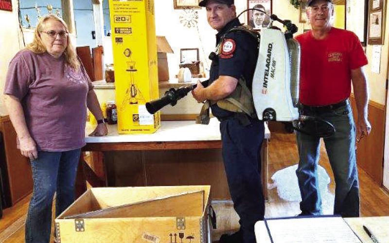 Last month, members of the Kinderhook Fire Association (KFA) donated a high-powered fire scene light and high-tech firefighting backpack to the Putnam County Fire Department. L-R: KFA Vice President Terea Jacobs with a PCFD firefighter and KFA President Elliott Perkins. (CONTRIBUTED)