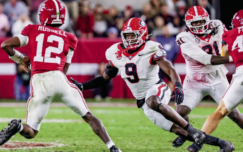 Georgia linebacker Chris Cole (9) pressures Alabama quarterback Keelon Russell (12). Cole totaled eight tackles in Tuscaloosa Saturday, along with a sack and two pass deflections. COURTESY OF UGA ATHLETICS