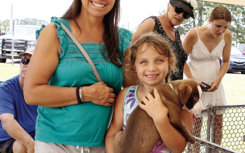 Kelsey and Lisa Petty held one of the 9-week-old puppies waiting for adoption. (LEIGH LOFREN/Staff)