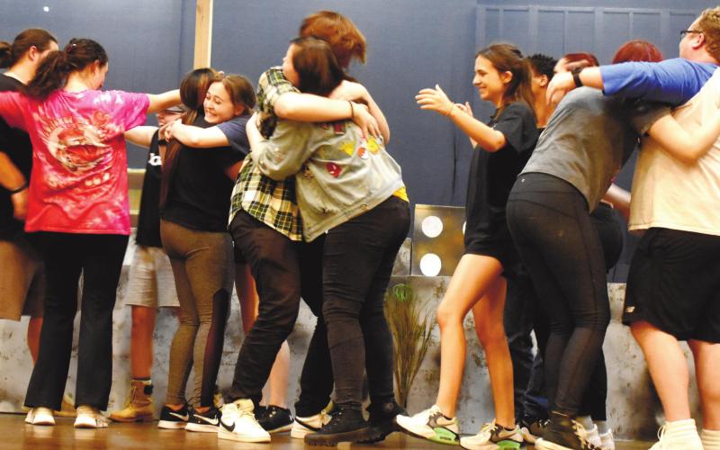 The “Godspell” cast practices a scene where the characters hug and rejoice after learning about Jesus’ everlasting love. BAILEY BALLARD/Staff
