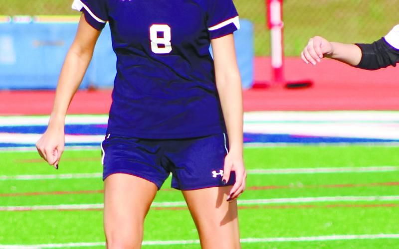Senior Jenna McDerment (8) approaches to challenge a Greene County player. ARELLA CASH/ Staff