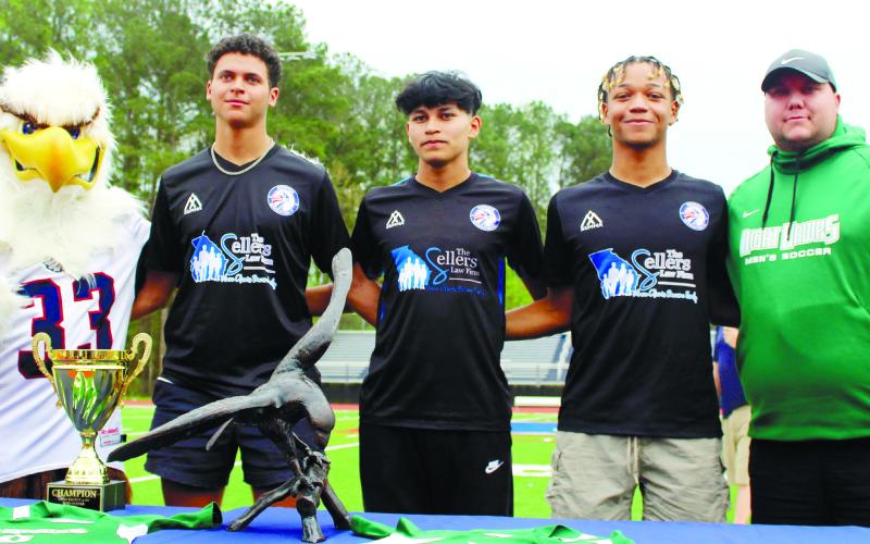 L-R: PCHS mascot “Swoop” joins rising seniors Marco Owenby, Brad Reeves, and Edwith Lopez, who all signed to play soccer while attending Thomas University starting this fall, with Thomas head coach Billy Jeffrey. ARELLA CASH/Staff