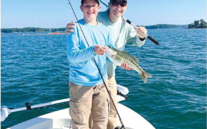Henry Cowen and Beau with a nice top water spotted bass CONTRIBUTED