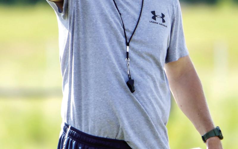Putnam County head coach Joel Harvin directs his players while they go through a drill during a spring practice in May. LANCE McCURLEY/Staff