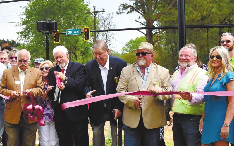 County Commission Chairman Billy Webster and, from left, Commissioners Bill Sharp, Gary McElhenney and Jeff Wooten cut the ribbon to commemorate the activation of the new traffic light at Scott Road and Lake Oconee Parkway Tuesday. T. MICHAEL STONE/Staff