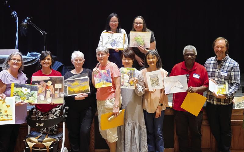 Artists with the artwork after the exchange. (CONTRIBUTED)