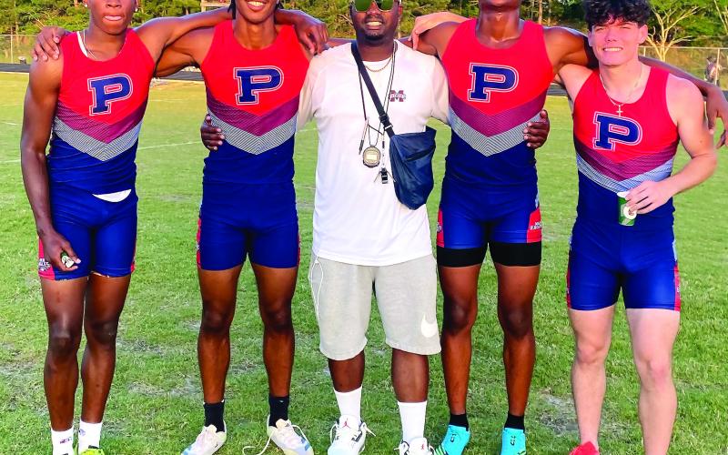 The Putnam County boys 4x400-meter relay team poses for a photo with coach Kedric Manning, celebrating their fifth-place finish at the state sectional meet. CONTRIBUTED