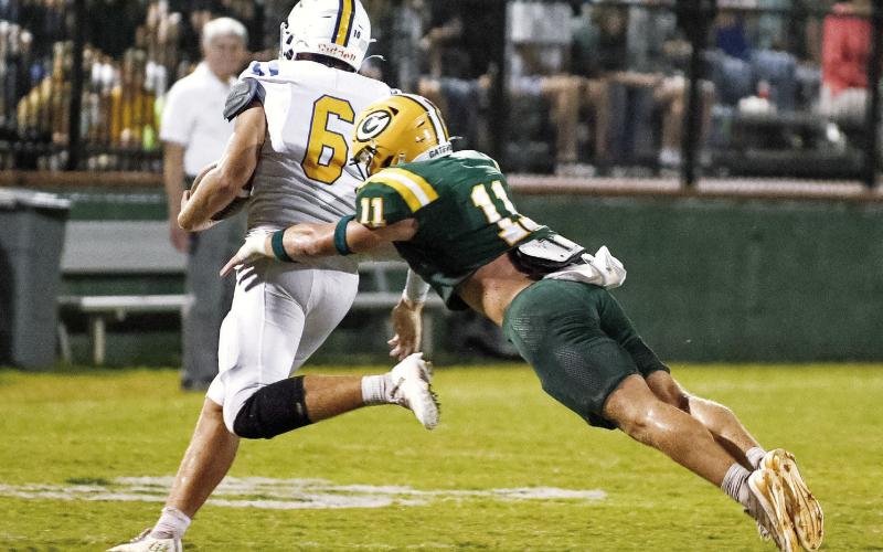 Gatewood’s Mason Sinclair (11) makes a flying takedown of Augusta Prep quarterback Carter Chavous at the start of the second half. IAN TOCHER/Staff