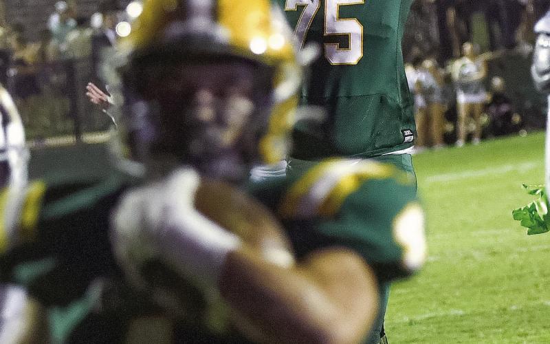 Gatewood lineman Drew Clevenger (75) reacts as Landon Moreno (4) crosses the goal line for another Gators touchdown against Augusta Prep last Friday. IAN TOCHER/Staff