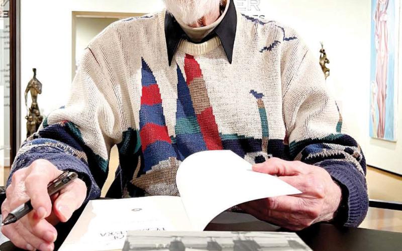 Willaim Charles “Chuck” Connor signs copies of his trilogy of books last Saturday at STMA in Buckhead. IAN TOCHER/Staff