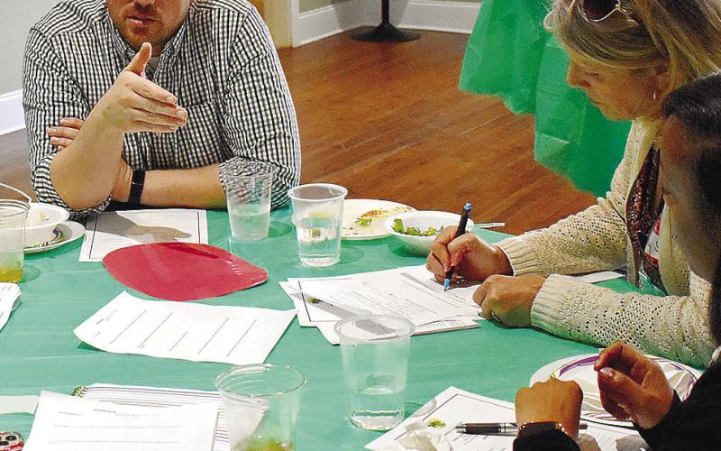 GaFCP Regional Manager Adam Swymer (center) joins a discussion in one of the small groups. LENA HENSLEY/Staff