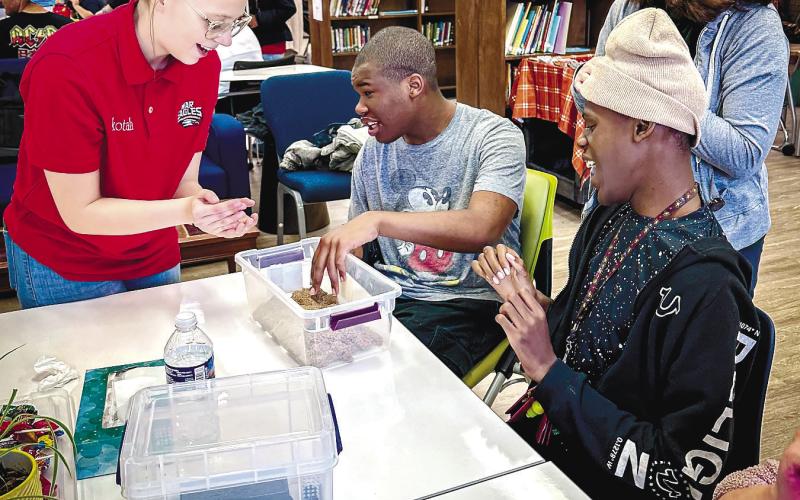 A Putnam County High School student (left) participated last week in a sensory exercise with students at the Georgia Academy for the Blind in Macon. CONTRIBUTED