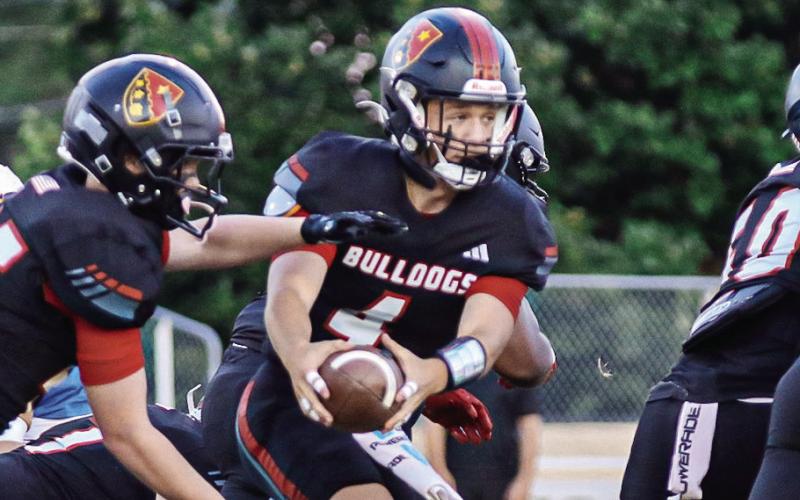 GMC Prep quarterback Cason Dennis (4) hands off the ball to a teammate last season. TREY NORRIS/Staff