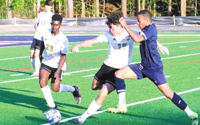 Marko Owensby battles with two Vidalia players for control of the play. KIM CASH/Staff