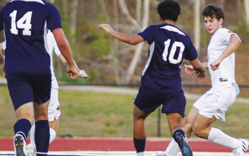 Putnam County junior midfielder Angel Sanchez (10) attempts a shot on goal against Lake Oconee Academy on April 1. TREY NORRIS/Staff