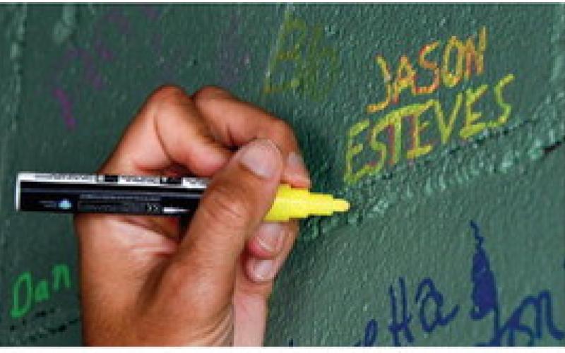 After delivering another speech to a small crowd there, Esteves took time to write his name among hundreds of others on the eatery’s wall. IAN TOCHER/Staff