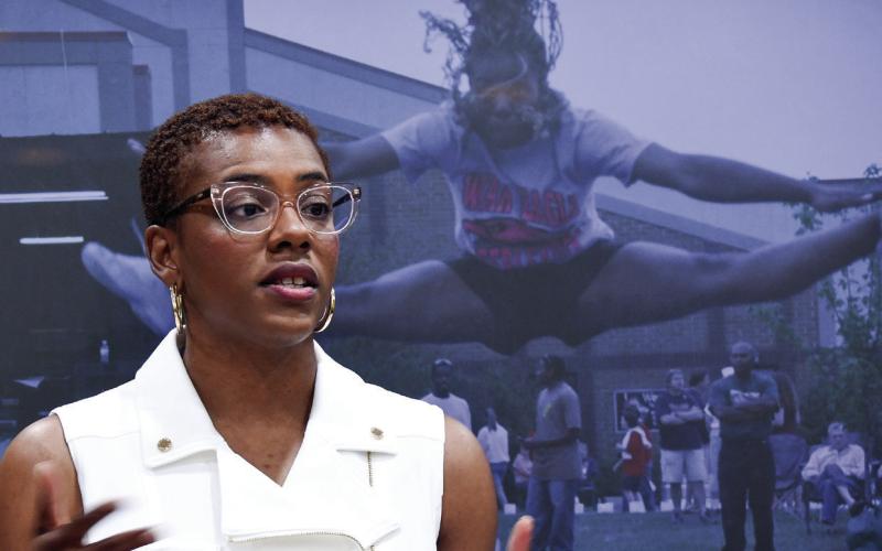 Standing in front of a photo of her as a Putnam High cheerleader, PCHS alum Thomaesa Bailey, who is now a lawyer and serves as campaign manager for Jason Esteves’ run for governor, also spoke to PCHS students and staff members. IAN TOCHER/Staff