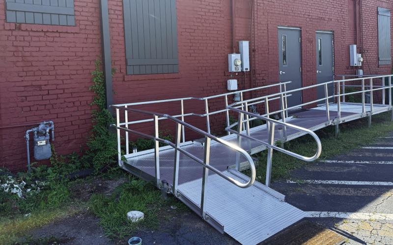 The most prominent features of the refurbished back entrance to the Georgia Writers Museum are the new wheelchair ramp, new doors, and decorative shutters covering long-ago bricked-in window openings. IAN TOCHER/Staff