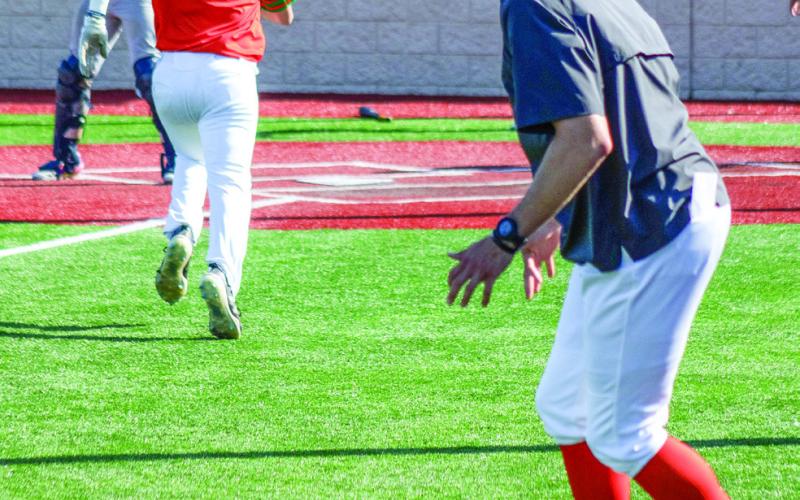 Tony Matos, the Wild Things’ head coach, watches as his players run the bases during a pivotal moment of the game. SKYLA MORRIS/Staff
