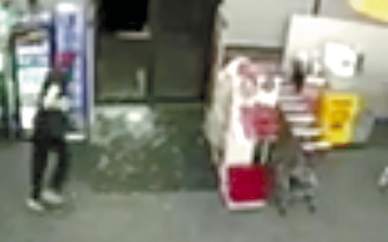 This copy of security camera footage, shared by EPD, reveals the second smash-and-grab, in which, after the burglar finds no money in the cash register, he helps himself to a Dr. Pepper on the way out the door. COURTESY OF EATONTON POLICE DEPARTMENT