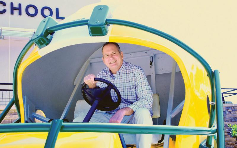 New Gatewood Head of School Jon Fadely takes a turn behind the wheel of the Gators’ football-themed golf cart, a fitting ride for the avid golfer who lives with his wife at Reynolds in Greene County. IAN TOCHER/Staff