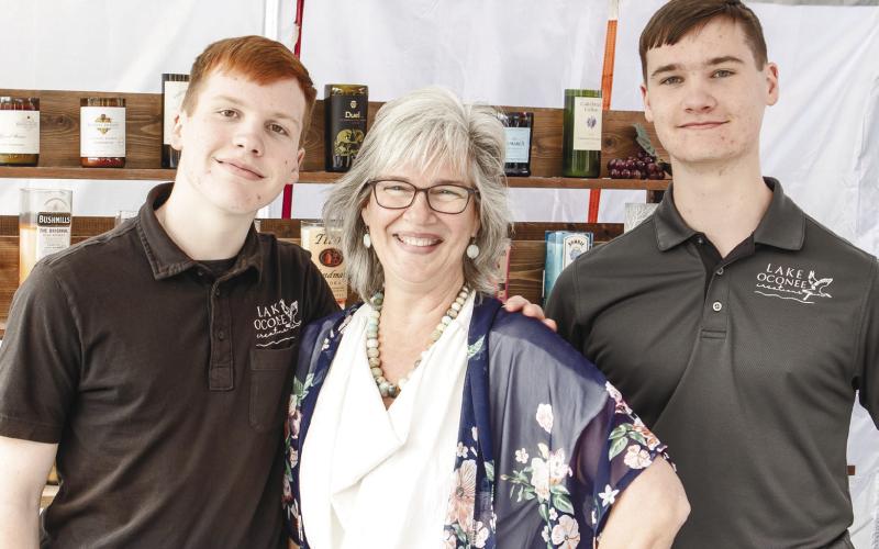 Daniel and Luke assist their mother, Melinda Spivey, at her booth on Saturday.