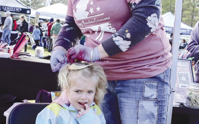 Emrie Kennedy gives a grin while getting her hair done at The Big Event.