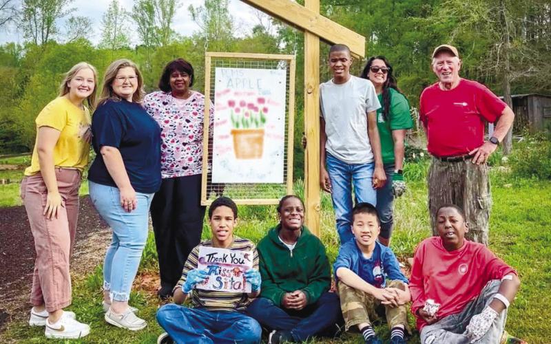 Student-teacher Taylor Casey (far left) worked closely with APPLE teacher Carla Dabbs (in sunglasses) to bring Putnam County Middle School students to Eatonton’s Butterflies and Blooms habitat. CONTRIBUTED