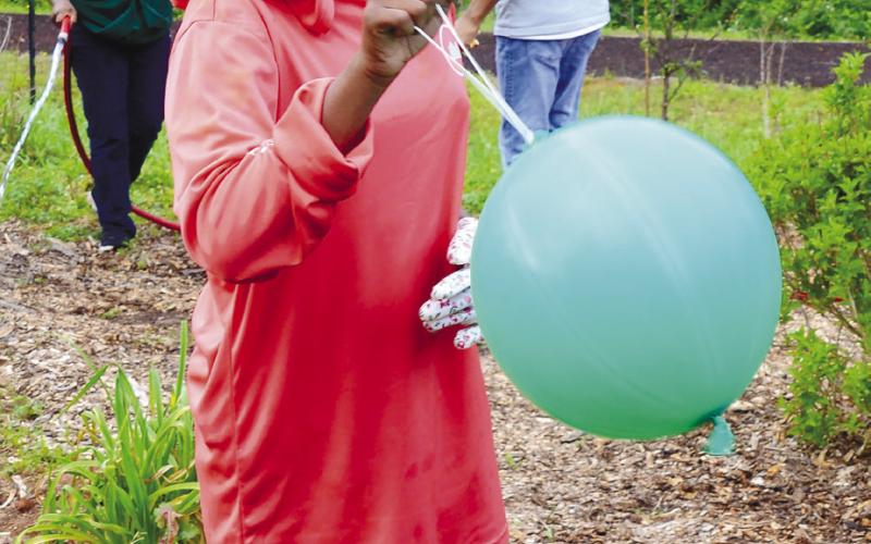 In addition to digging and watering and planting, there was time for students to have fun and simply enjoy the park-like atmosphere at Butterflies and Blooms. IAN TOCHER/Staff