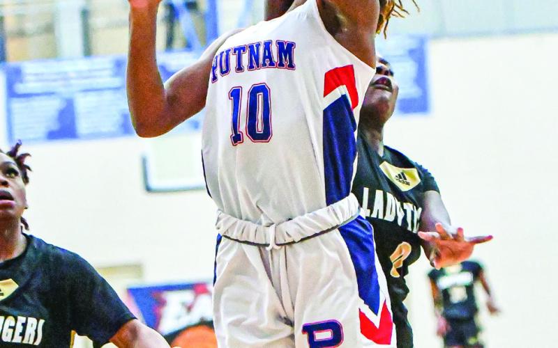 Lady War Eagles’ freshman Journey Waller (10) goes up for a contest layup against Greene County.