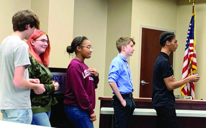 PCHS students Ty Young, Hunter Cousino, Taylor Wilson, Aidan Brock and Cameron Lawson tell the board about their experiences at the conference. BAILEY BALLARD/Staff