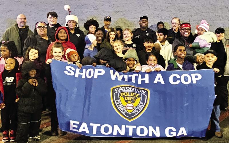 Kids and officers participating in Eatonton Police Dept.’s annual Shop with a Cop program are all smiles before heading into Walmart for their shopping sprees. CONTRIBUTED