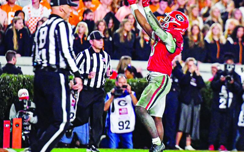 Georgia freshman running back Nate Frazier waves to the crowd after scoring his only touchdown of the game against Tennessee. CHARLES JORDAN/Staff
