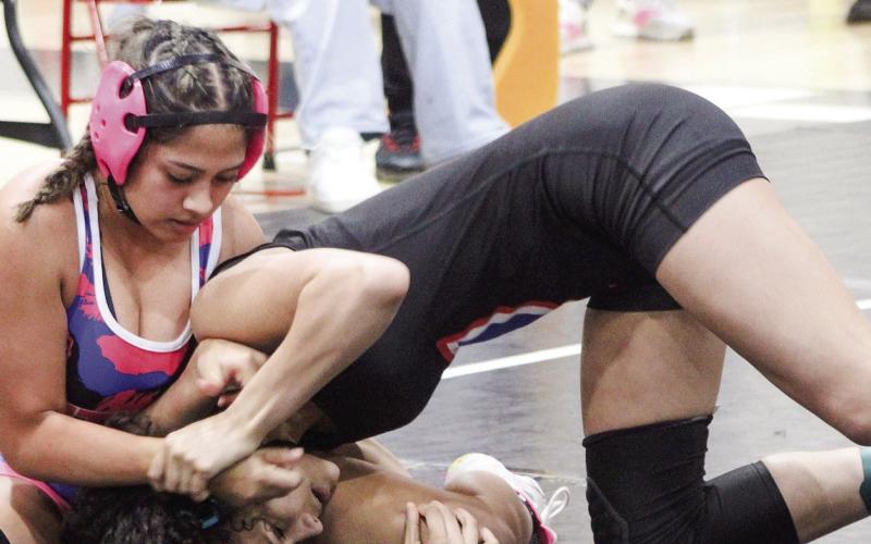 Putnam County’s Michelle Hernandez (left) tries to pin an opponent during a tournament match in the regular season. KIM CASH/ Contributed