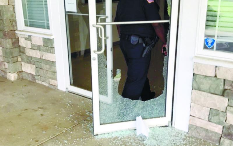 Glass in the entry doors of the community center at Jimmy Davis Park is shattered and scattered on the walkway after a rock was thrown through the doors. The rock was discovered all the way across the interior room, suggesting it slid that far when thrown, authorities say. CONTRIBUTED/EPD