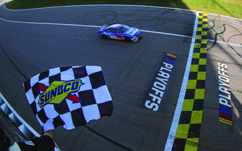 Bubba Wallace, driver of the #45 ROOT Insurance Toyota, takes the checkered flag to win the Cup Series Hollywood Casino 400 at Kansas Speedway Sunday. (Meg Oliphant/Getty Images)