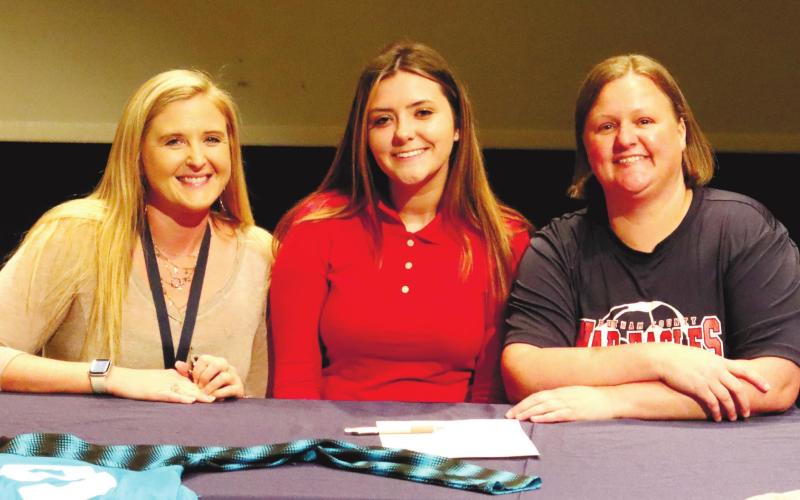 It was a happy day at Putnam Cough High School as (l-r) Jessica Castillo (assistant soccer coach), Tesa Shelton, Brandi Barling (head coach) celebrate Tesa’s scholarship to GMC. LANCE MCCURLEY /Staff