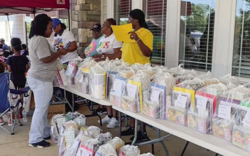 The tables were piled high with back-to-school supplies on Saturday morning when the Jimmy Davis Park Partnership Advisory Council held a community-wide Back-to-School Rally at the park near downtown Eatonton. CONTRIBUTED
