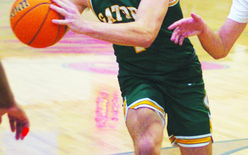 Senior Ames Johnson, quarterback for the Gatewood football team, has steadily improved as a contributor on the court this season, too. IAN TOCHER/Staff
