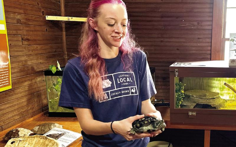 Mikell introduces Wuji, a slider turtle, to the crowd. ALIVIA BLANTON/Staff
