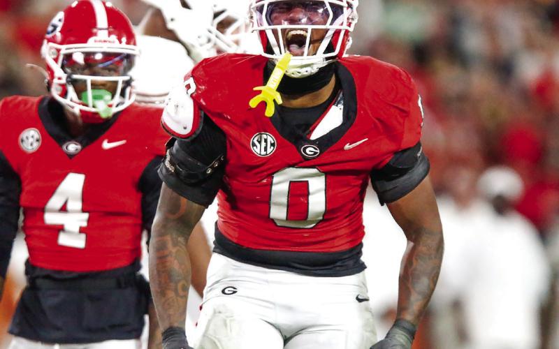 Georgia edge rusher Gabe Harris (0) celebrates after sacking Texas quarterback Arch Manning. LANCE McCURLEY/Staff