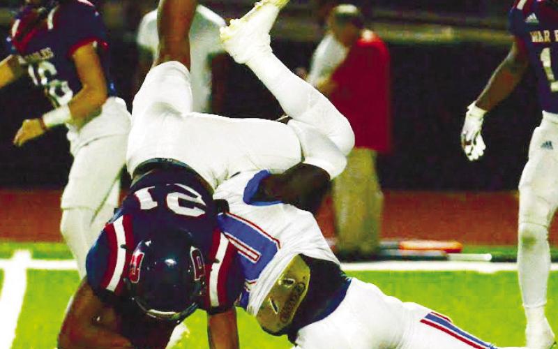 Freshman running back Blake Williams (21) made an acrobatic attempt to gain an extra yard for Putnam early in the second half against Westside last Friday night. IAN TOCHER/Staff
