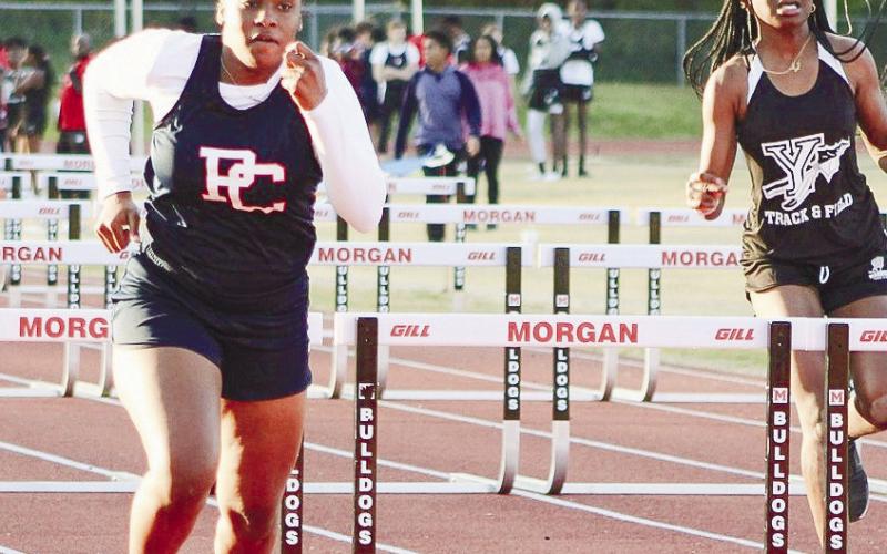 A PCMS girls' runner competes in the 110-meter hurdle. ARELLA CASH/Staff
