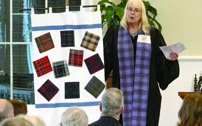 Rev. Meg Jackson Clarke speaks of the tartan. LEIGH LOFGREN/Staff