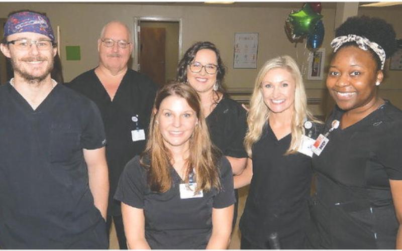 New PGH Director of Therapy Services Jana Weems (seated) will be supported by (l-r): physical therapist Ryan Faircloth, occupational therapy assistant Tim Belkins, office manager D.J. Holder, speech-language pathologist Brooke McMillen and physical therapy assistant Tequilla Reid. IAN TOCHER/Staff