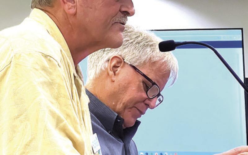 Land developer George Kelecheck (foreground) and Greg Ramsey, design chief of Asheville, N.C.based Village Habitat Design, gave an extensive presentation about the benefits of long-term development planning to the Putnam BOC. IAN TOCHER/Staff
